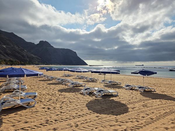 Neatly arranged sunbeds and umbrellas face the Atlantic, offering a peaceful environment to enjoy the ocean breeze.